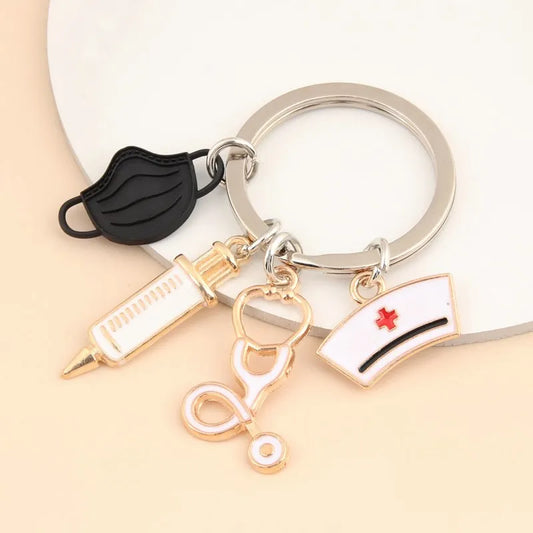 A cute nurse‑themed stethoscope keyring featuring a medical mask and syringe charm, perfect for bags, purses, and everyday accessories.